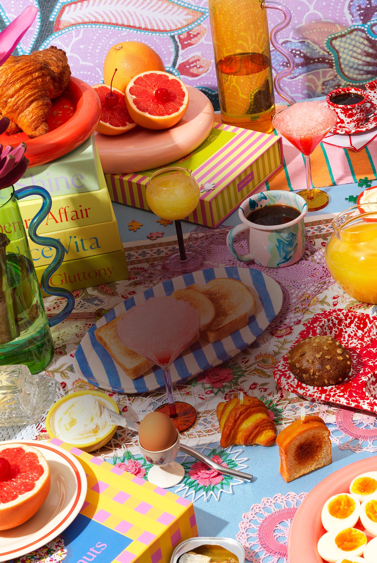 Brunch lifestyle scene showcasing a vibrant scene of puzzle boxes and other gifts and goods on a table
