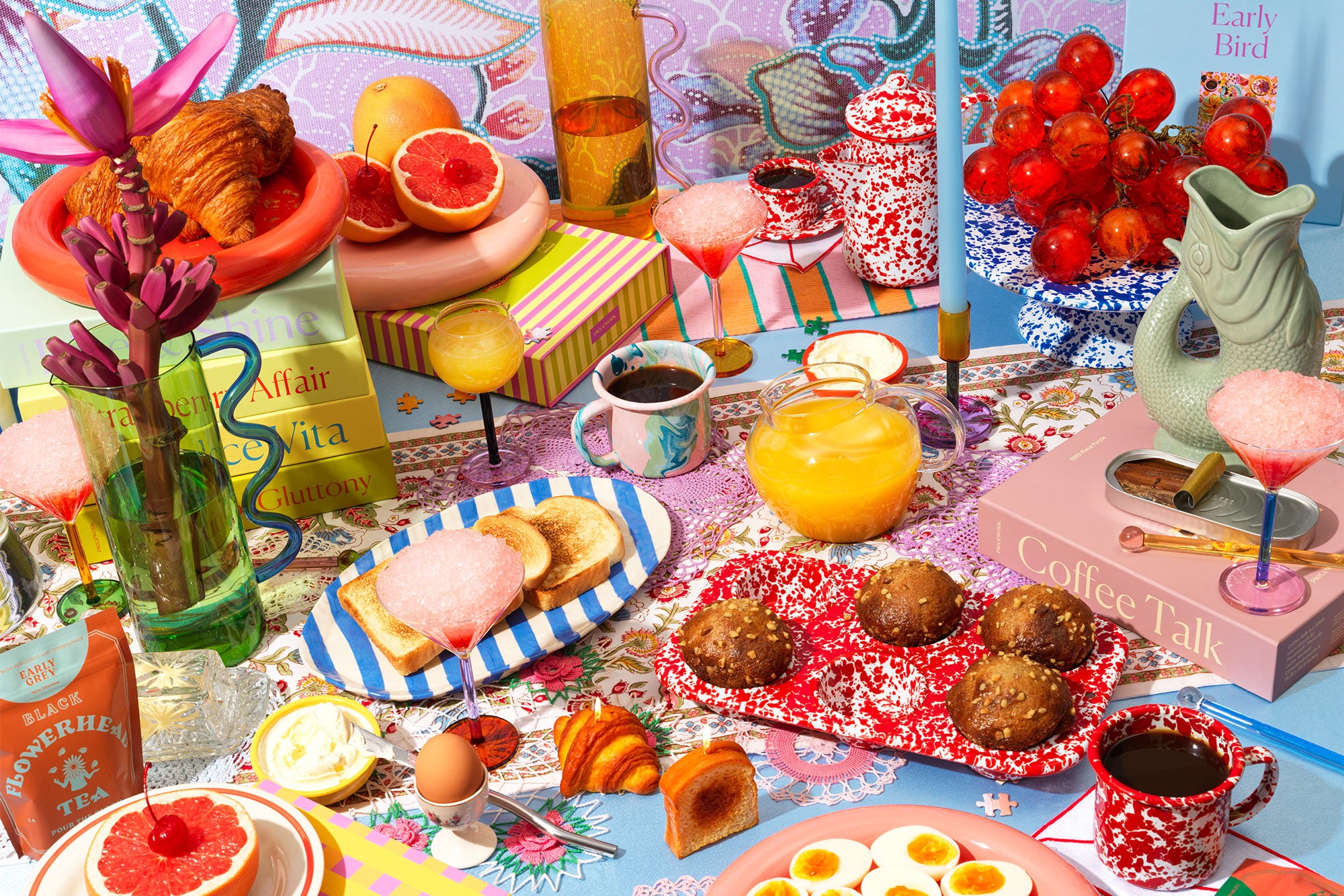 Brunch lifestyle scene showcasing a vibrant scene of puzzle boxes and other gifts and goods on a table