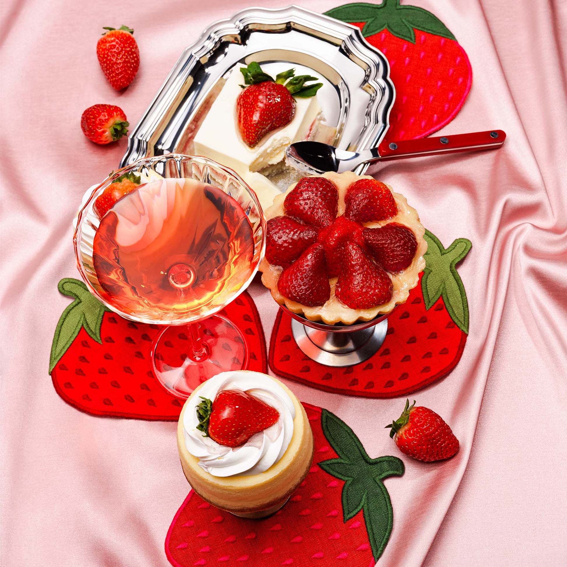 Strawberry-shaped linen cocktail napkins by Piecework styled with strawberry desserts and rosé.