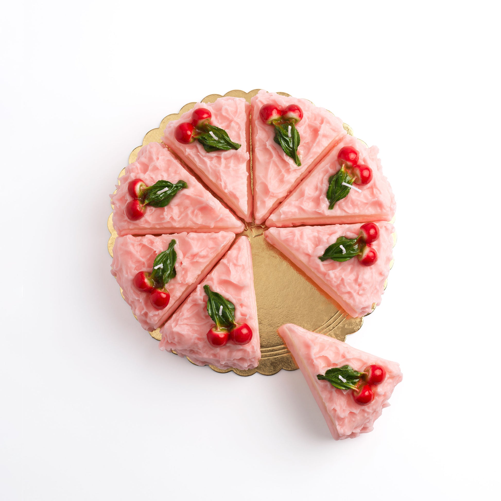 Eight Cherry Cake Slice Candles arranged on a cake platter like a sliced circle cake with a piece being cut out.