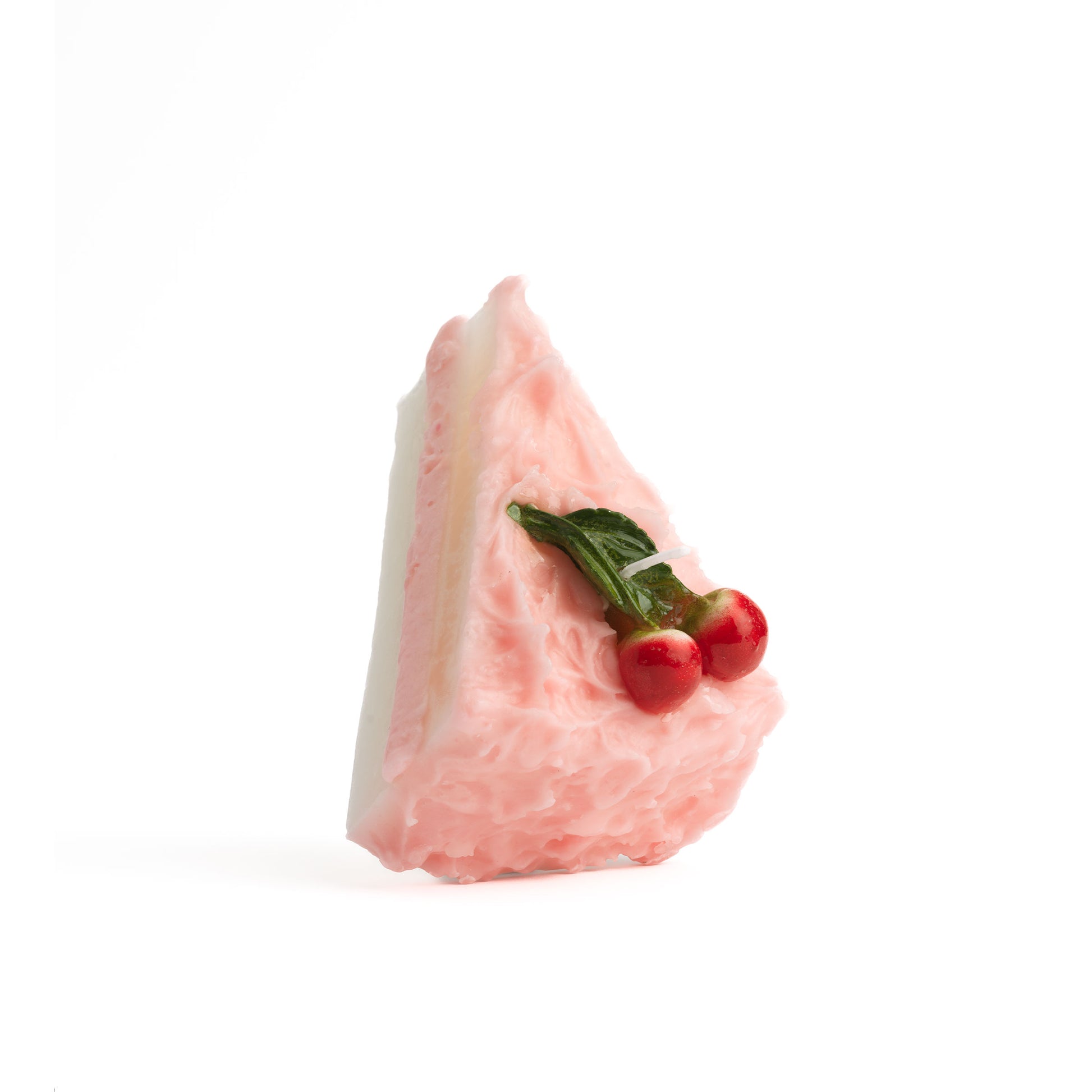 A single Cherry Cake Slice Candle on white seamless background.