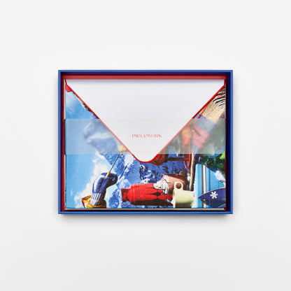 Piecework Après Ski Stationery Set: open cobalt blue box of alpine fondue notecards and envelopes under a vellum band