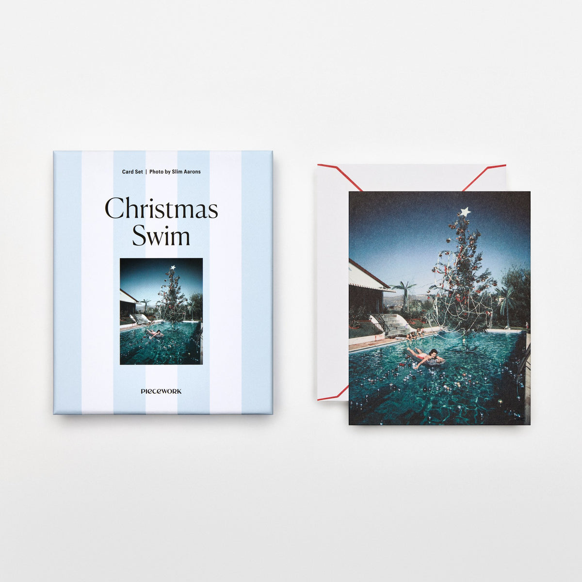 Piecework Christmas Swim Stationery Set: blue-striped box and Slim Aarons card of a poolside Christmas tree, plus envelope
