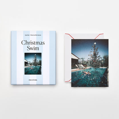Piecework Christmas Swim Stationery Set: blue-striped box and Slim Aarons card of a poolside Christmas tree, plus envelope