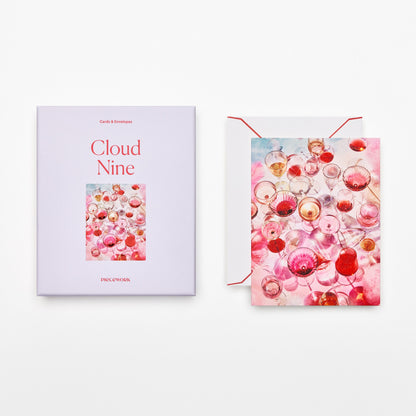 Piecework Cloud Nine Stationery Set: lavender box and notecard of pink and rosé glasses, plus envelope