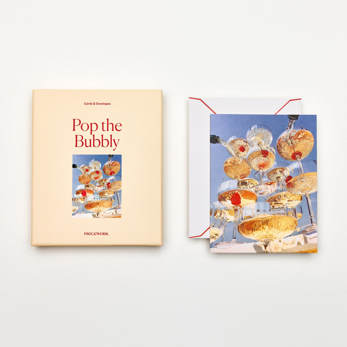 Piecework Pop the Bubbly Stationery Set: peach box and notecard of a champagne coupe tower, plus envelope