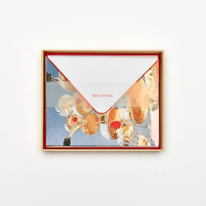 Piecework Pop the Bubbly Stationery Set: open peach box of champagne tower notecards and envelopes under a vellum band