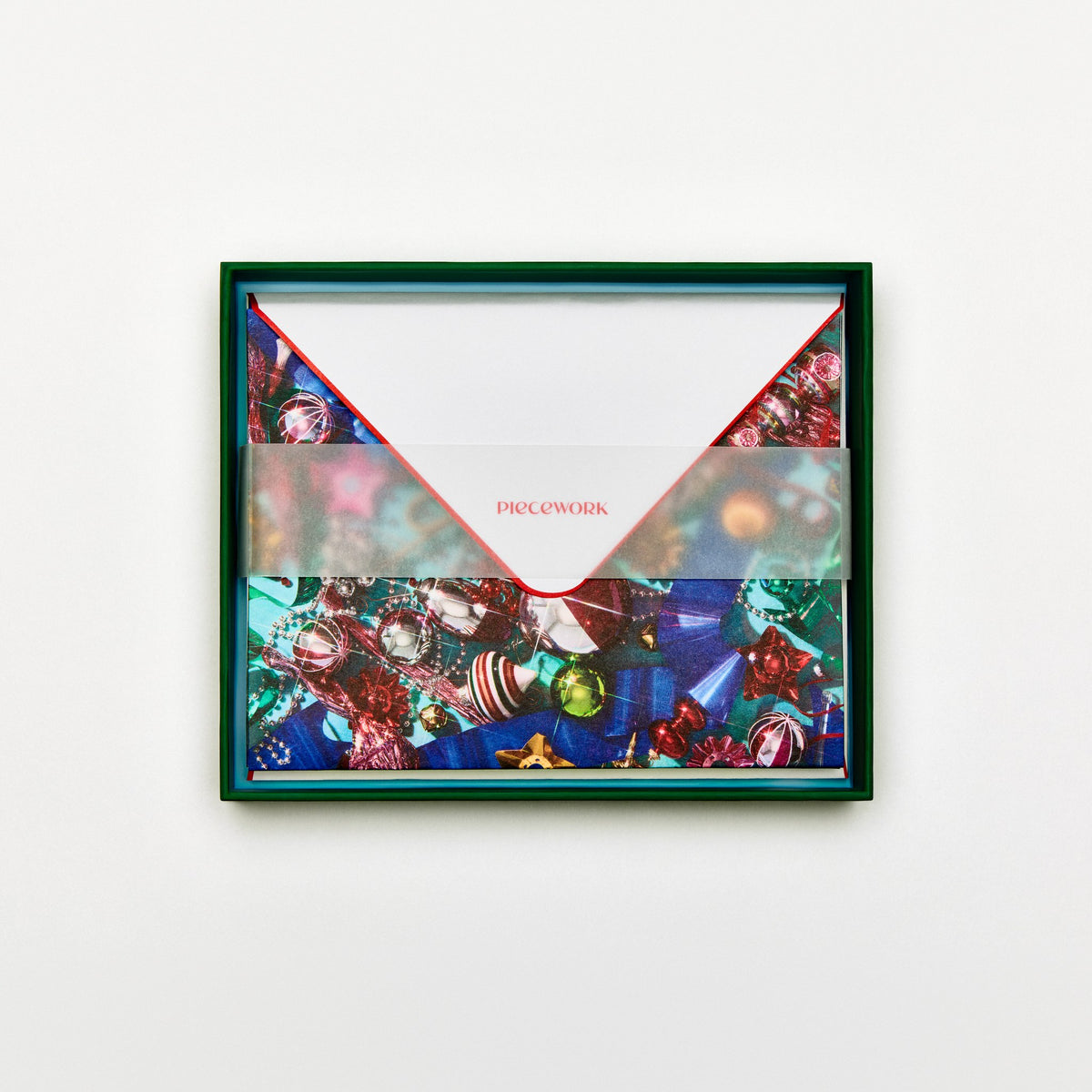 Piecework Tinseltown Stationery Set: open deep green box of holiday ornament notecards and envelopes under a vellum band