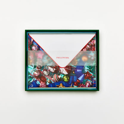 Piecework Tinseltown Stationery Set: open deep green box of holiday ornament notecards and envelopes under a vellum band