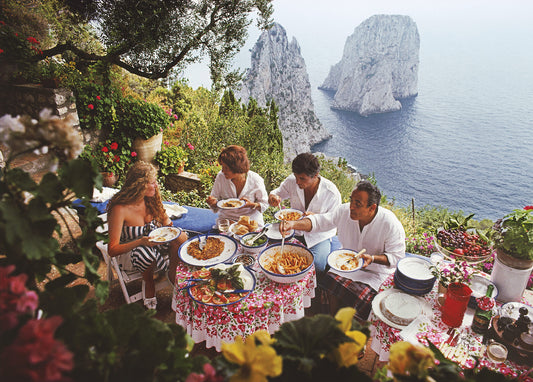Dining al Fresco on Capri – A serene Mediterranean scene captured by Slim Aarons, featuring an elegant terrace with a long dining table set against the stunning backdrop of Capri's coast. The atmosphere evokes timeless leisure, perfect for the 'Dining al Fresco on Capri' 1000-piece puzzle.