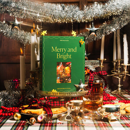 Piecework Puzzles' 1000-piece puzzle Merry and Bright photographed in a tabletop scene is filled with flickering candlesticks, tinsel and tartan.