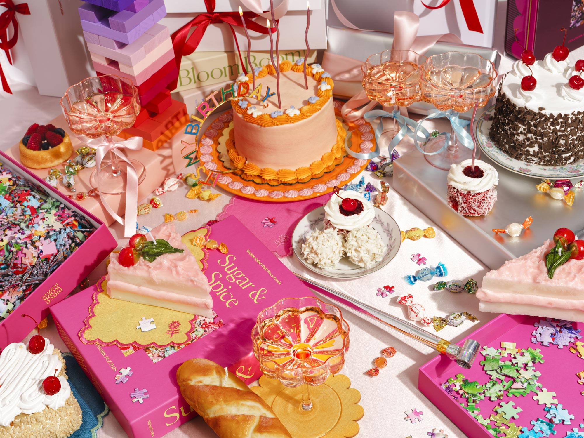 A curated selection of birthday gift ideas featuring stylish puzzles, decadent desserts, sparkling glassware, and festive party decor—perfect for celebrating in style.