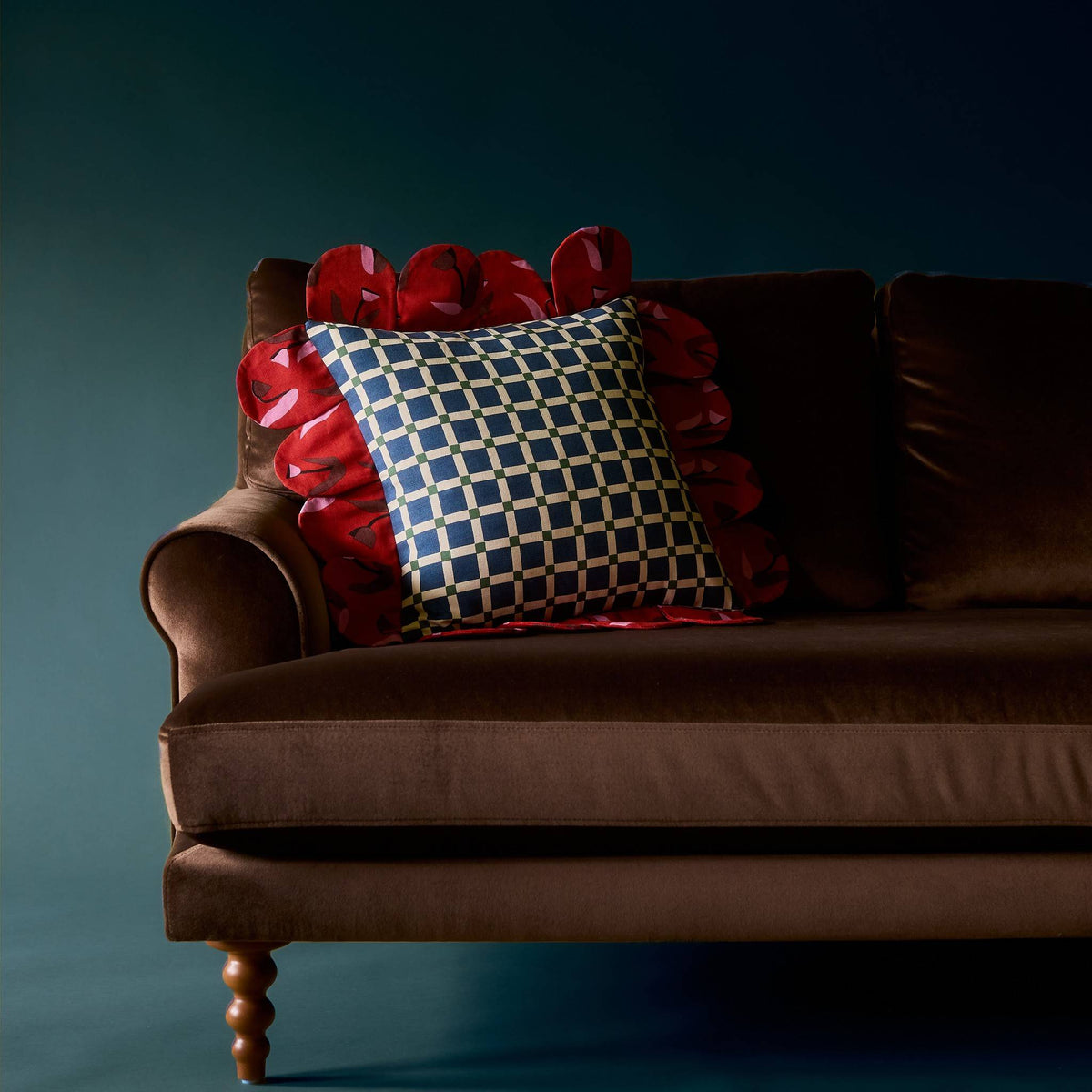 Blue Window Petal Pillow on a brown velvet sofa