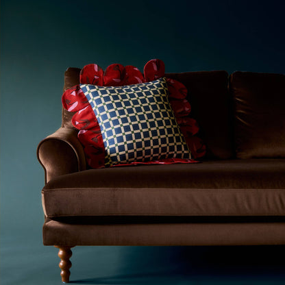 Blue Window Petal Pillow on a brown velvet sofa