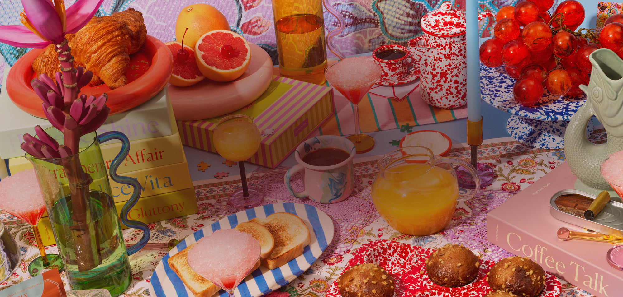 Scene of a brunch table filled with food and drink, puzzles and gift items.
