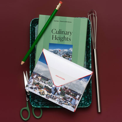 Piecework Culinary Heights Stationery Set: green-striped box and Slim Aarons notecard on a tray with whisk and scissors