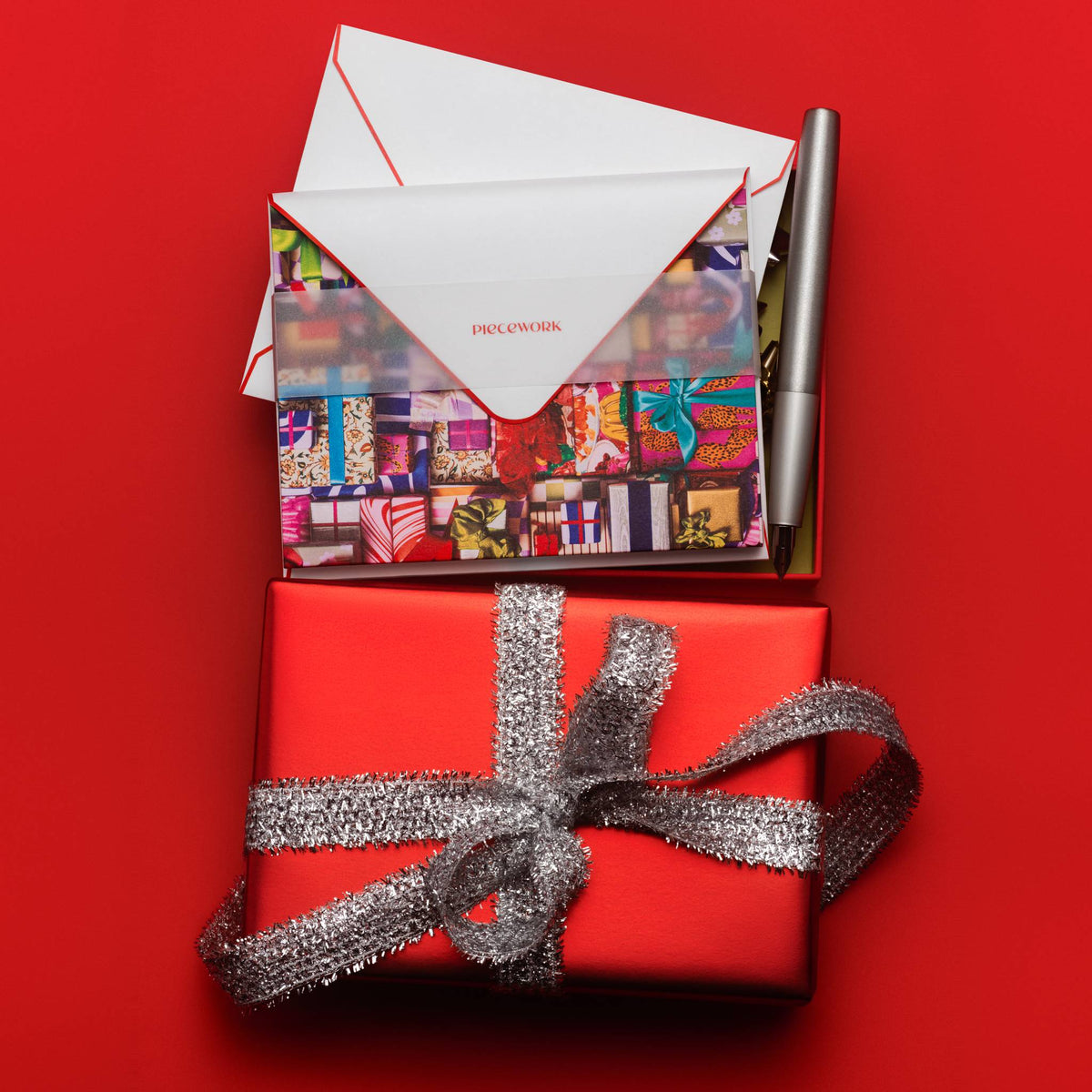 Piecework Fa La La La La Stationery Set: open box of notecards on a red gift tied with silver ribbon