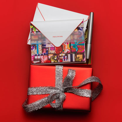 Piecework Fa La La La La Stationery Set: open box of notecards on a red gift tied with silver ribbon
