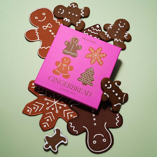 Pink gingerbread-themed cocktail napkin gift set. Featuring decorative gingerbread cookie linen napkins on a light green background.
