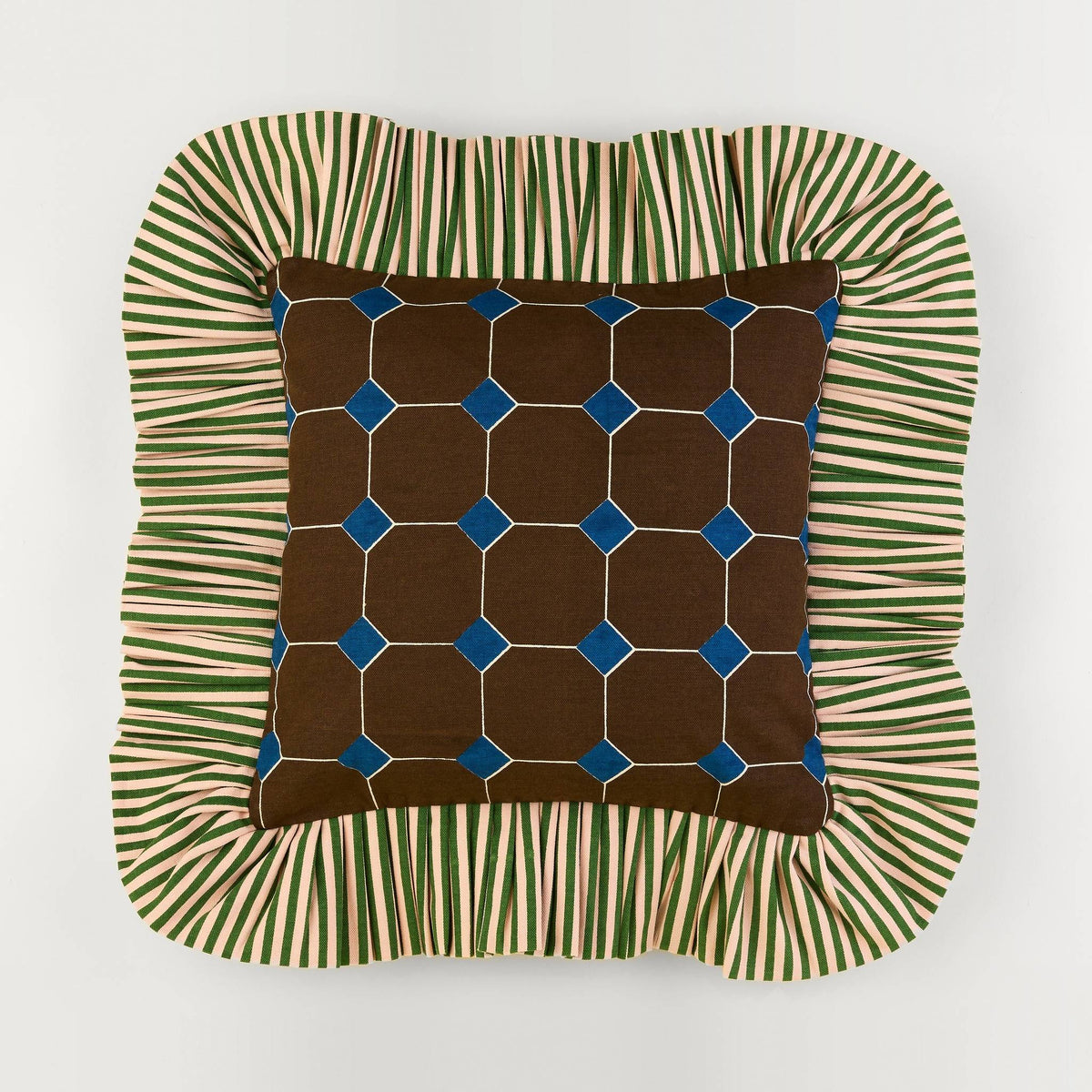 Jewel Stripe Ruffle Pillow front: brown tile print with blue jewels and a green striped ruffle