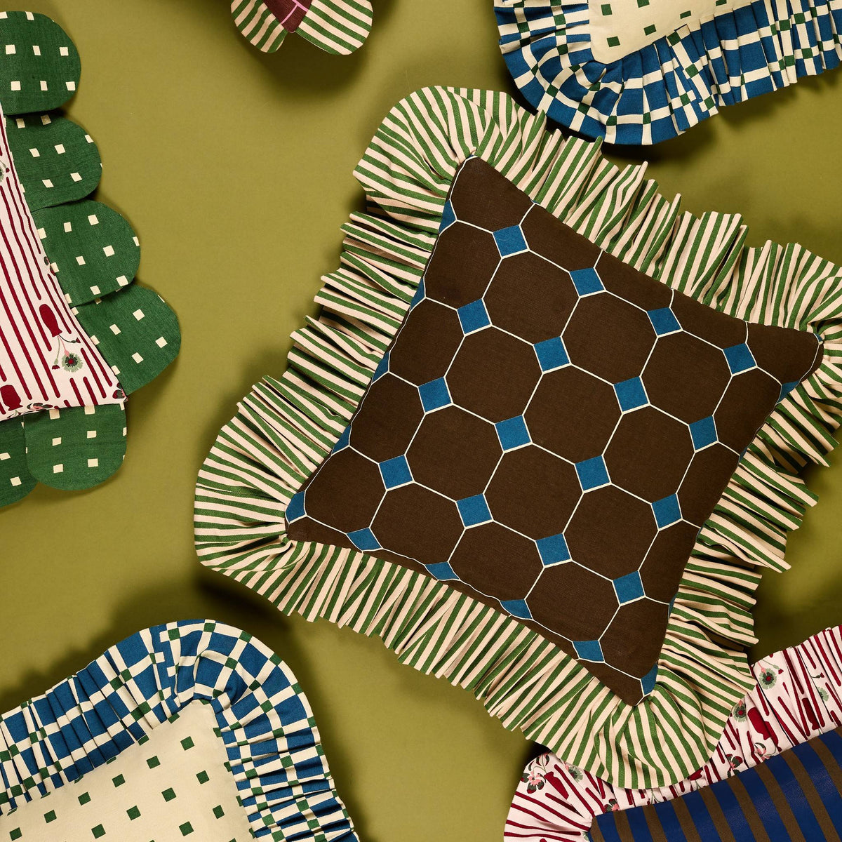 Jewel Stripe Ruffle Pillow from above, surrounded by other Piecework pillows