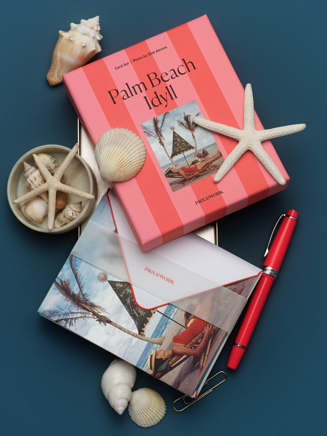 Piecework Palm Beach Idyll boxed notecard set in pink stripes with starfish, seashells, red pen and envelope on navy