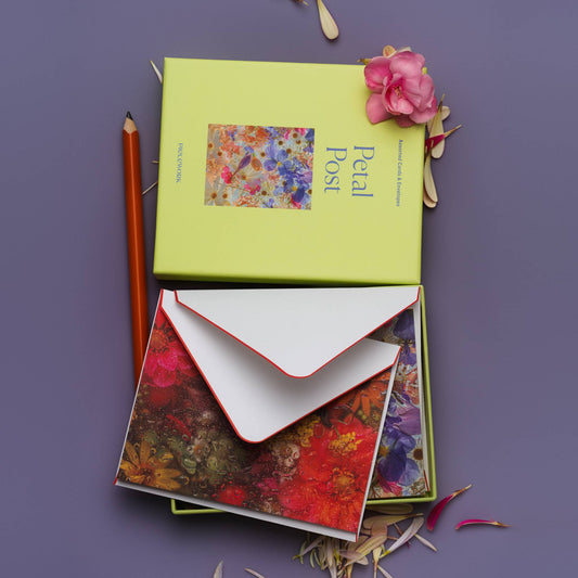 Piecework Petal Post Stationery Set: lime box above an open tray of dewy floral notecards and envelope on purple