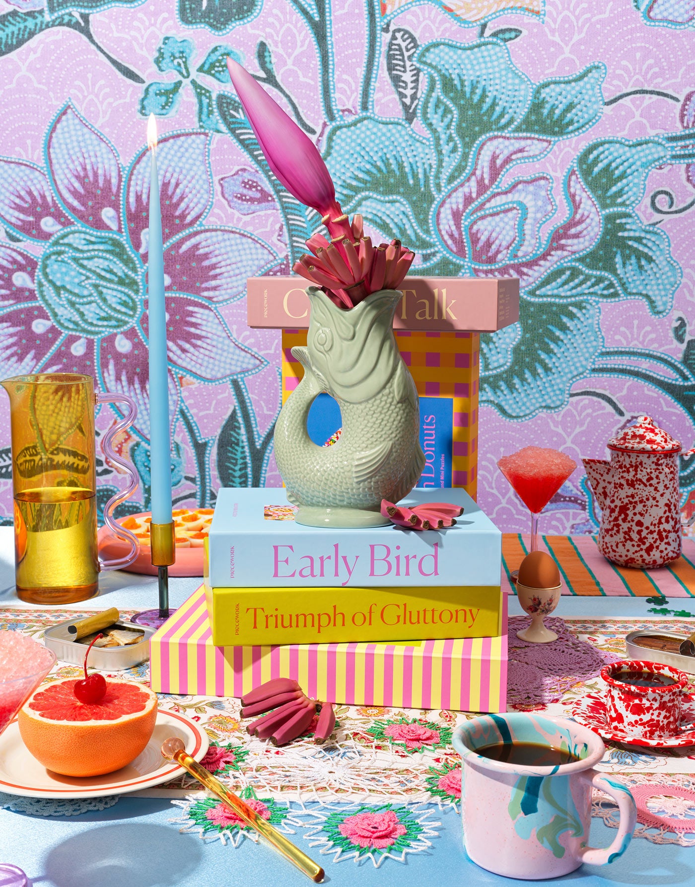 Brunch lifestyle scene showcasing a vibrant scene of puzzle boxes and other gifts and goods on a table