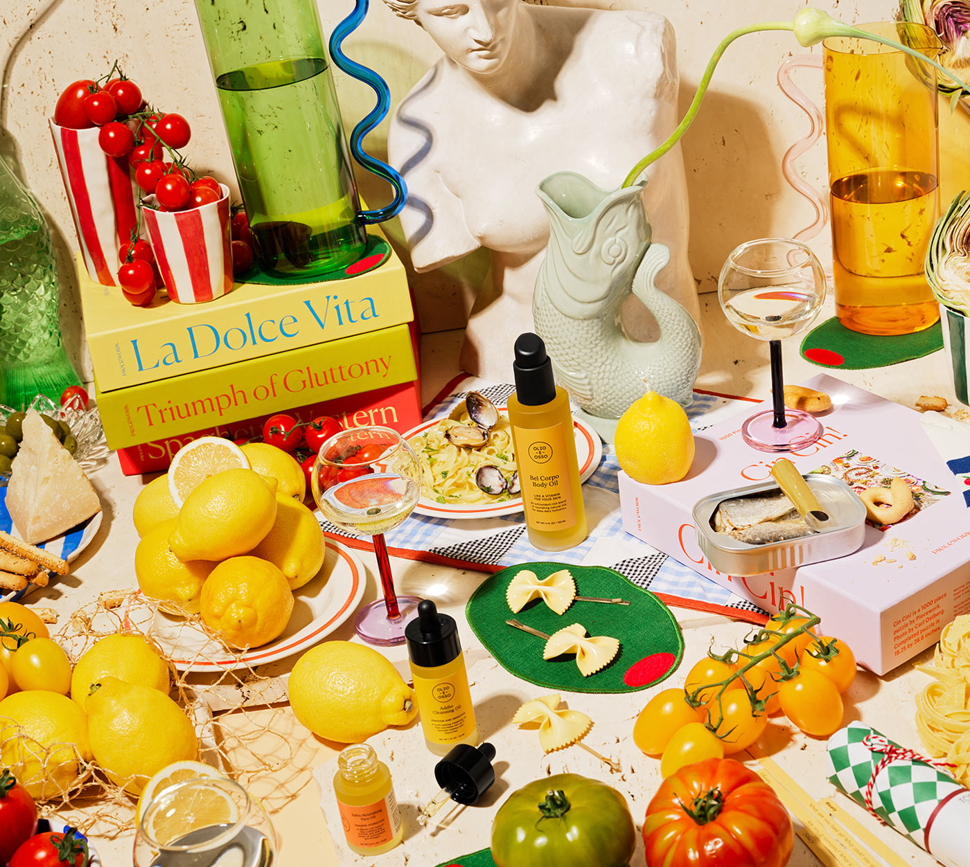 An Italy-themed scene filled with puzzles and other gifts and goods, e.g. the La Dolce Vita puzzle, wine glasses, olive cocktail napkins, and farfalle barrettes