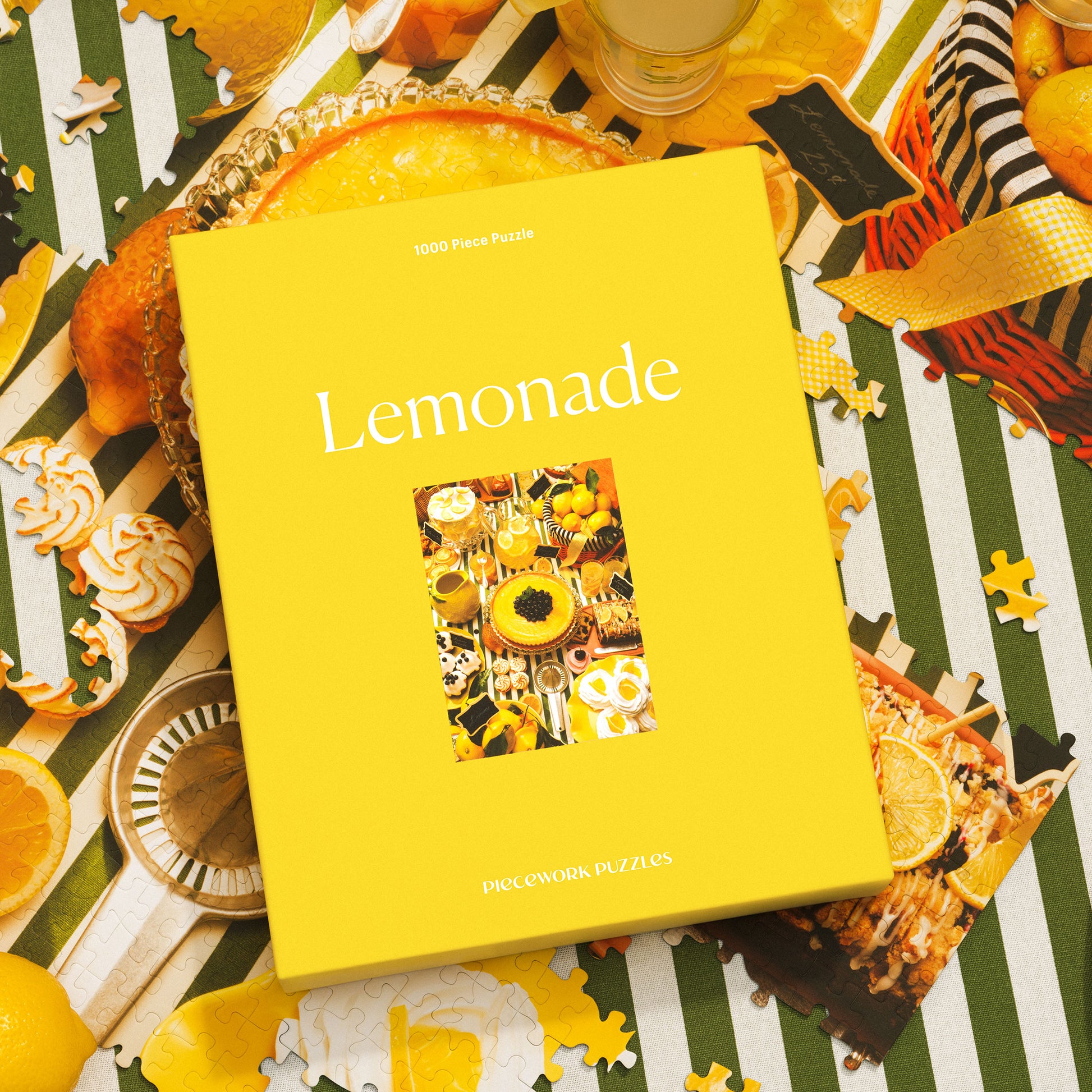 Lemonade, a 1000-piece puzzle, shown on a striped surface surrounded by puzzle pieces.