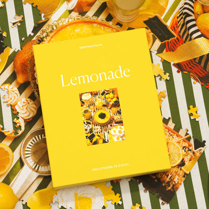 Lemonade, a 1000-piece puzzle, shown on a striped surface surrounded by puzzle pieces.