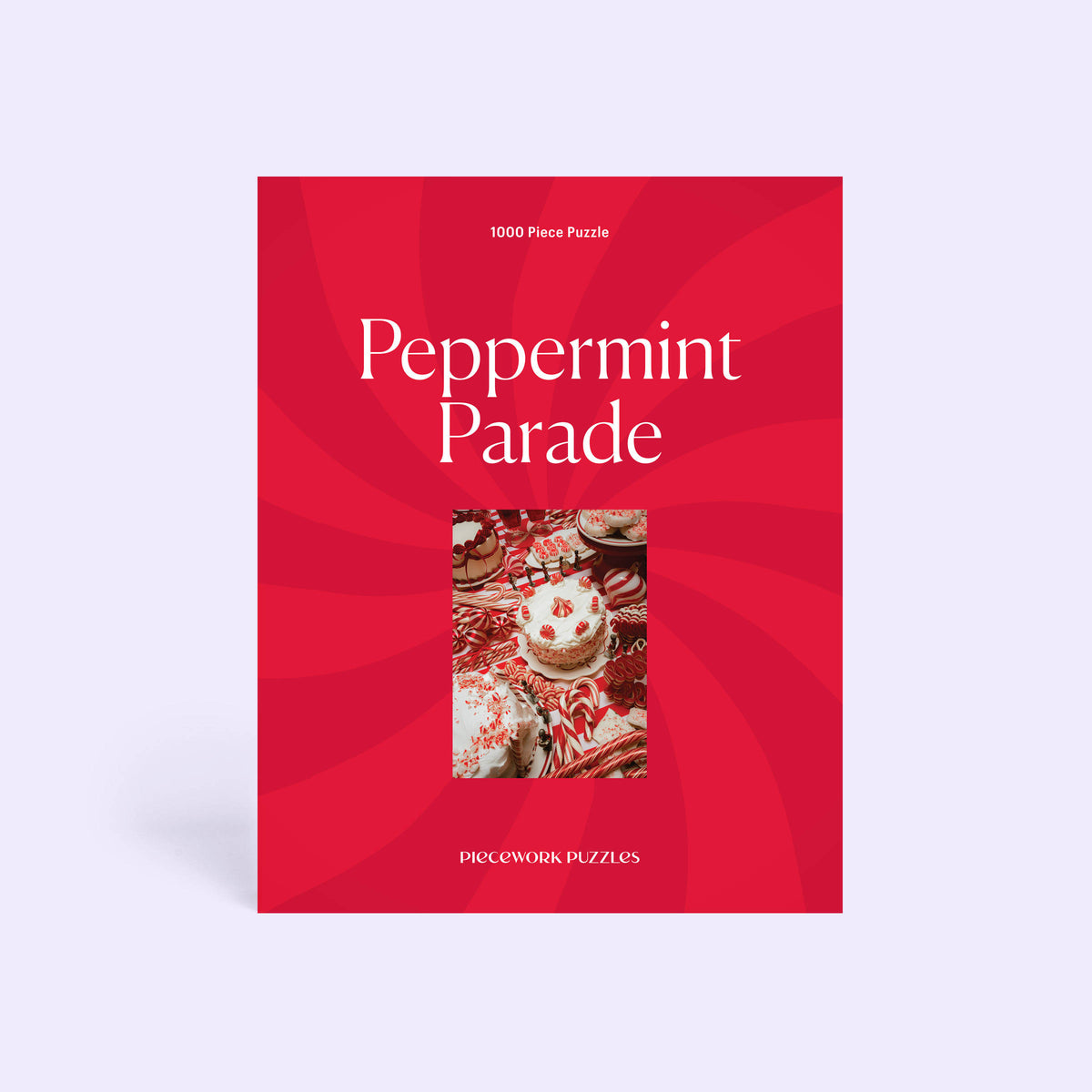 Front of the Peppermint Parade 1000-piece puzzle box: a red peppermint swirl design framing the candy dessert table art