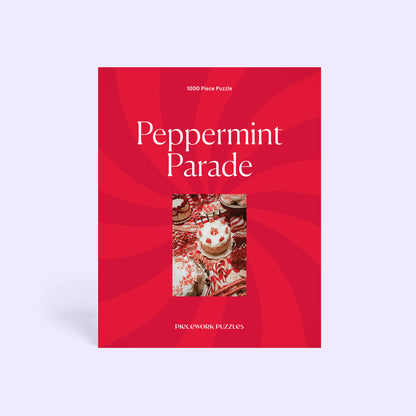 Front of the Peppermint Parade 1000-piece puzzle box: a red peppermint swirl design framing the candy dessert table art