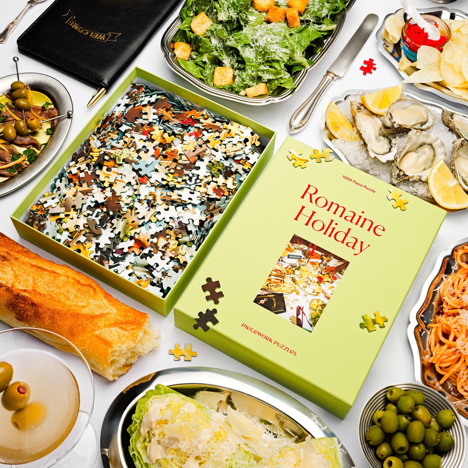 Puzzle box titled 'Romaine Holiday' surrounded by food items on a table.