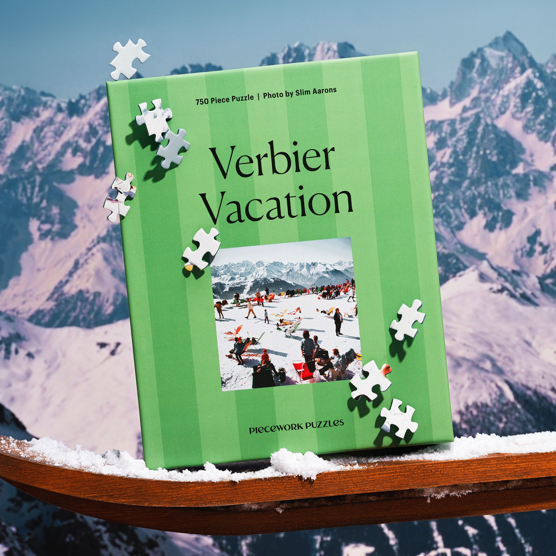 Green striped puzzle box titled 'Verbier Vacation' with puzzle pieces on a snowy mountain background