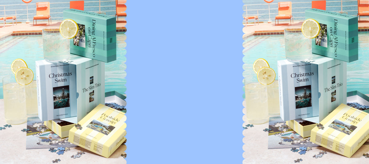 Slim Aarons Trio Set shown poolside with the Poolside Gossip, Dining Al Fresco on Capri, and Christmas Swim puzzle boxes open beside lemonade glasses and scattered puzzle pieces. Image shown twice with blank space in the middle