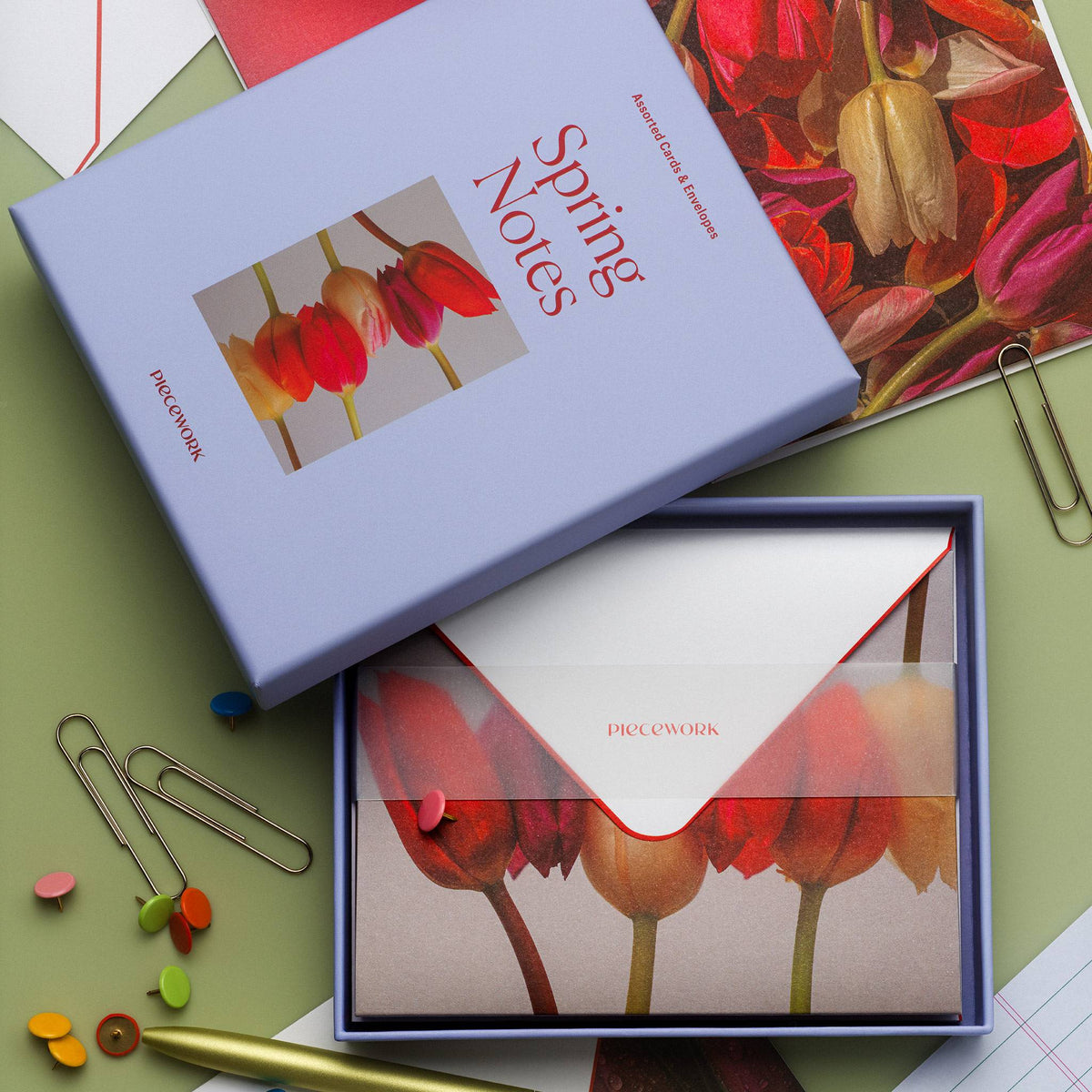 Piecework Spring Notes Stationery Set: periwinkle box and open tray of tulip notecards with paper clips on sage