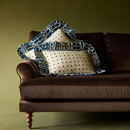 Two Tiny Checks Ruffle Pillows on a brown velvet sofa