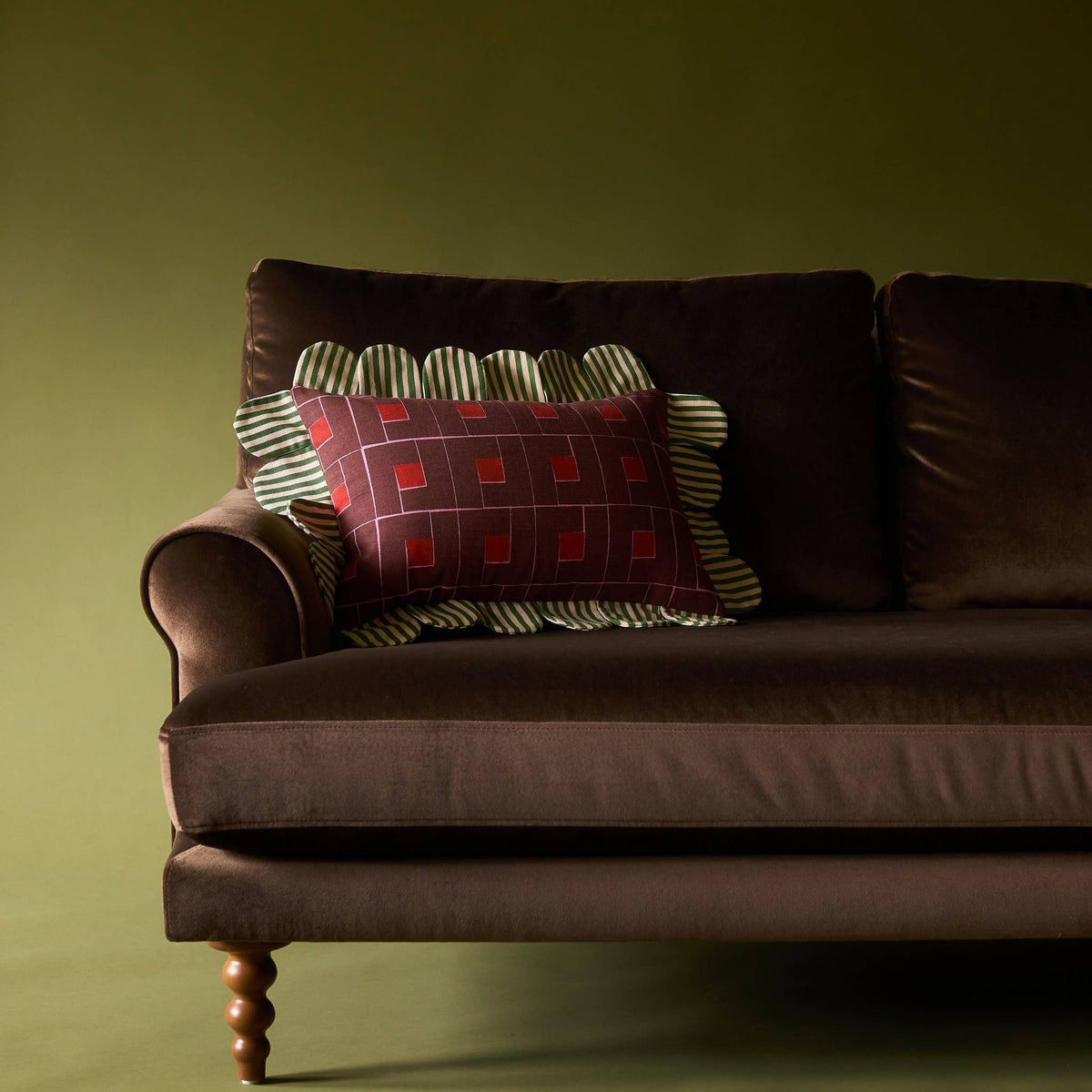 Venetian Check Petal Pillow on a brown velvet sofa