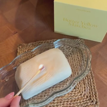 Video shows a butter candle being lit with a Piecework butter yellow match.