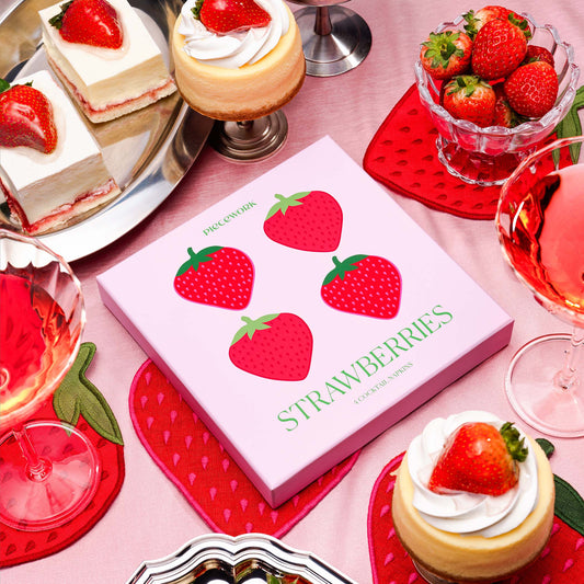 Piecework strawberry cocktail napkin gift box styled with desserts, drinks, and strawberries.